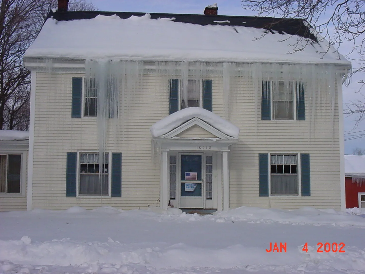 Roofing professional holding up advanced asphalt shingle roofing materials—protection for shingle roof longevity
