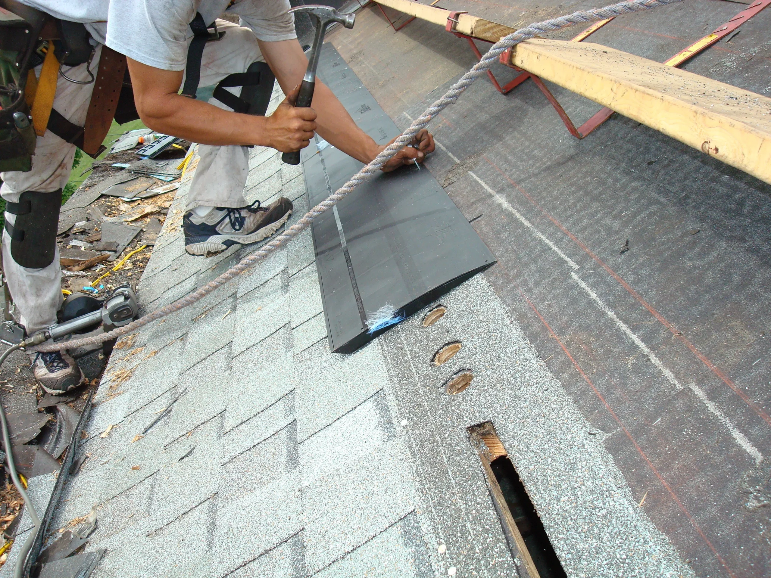 Contractor adding attic insulation to extend the life of your roof and prevent ice dams