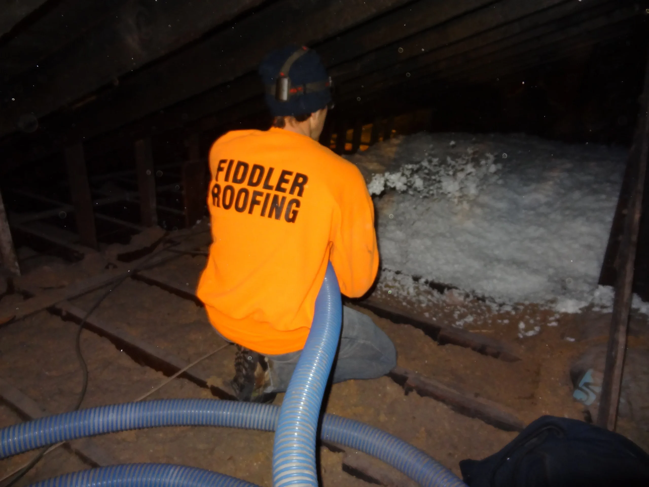 Careful handyman applying sealant to roof flashing, preventing roof leaks and costly repairs to extend your roof’s life