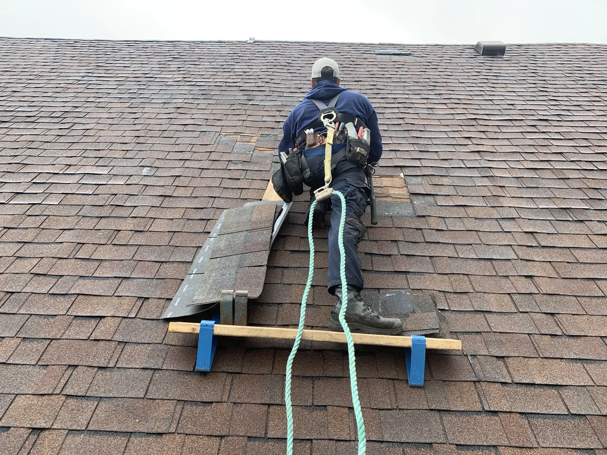 Diverse roofing materials—flat roof, metal panels, asphalt shingle—maintenance tools, roof maintenance checklist, photorealistic
