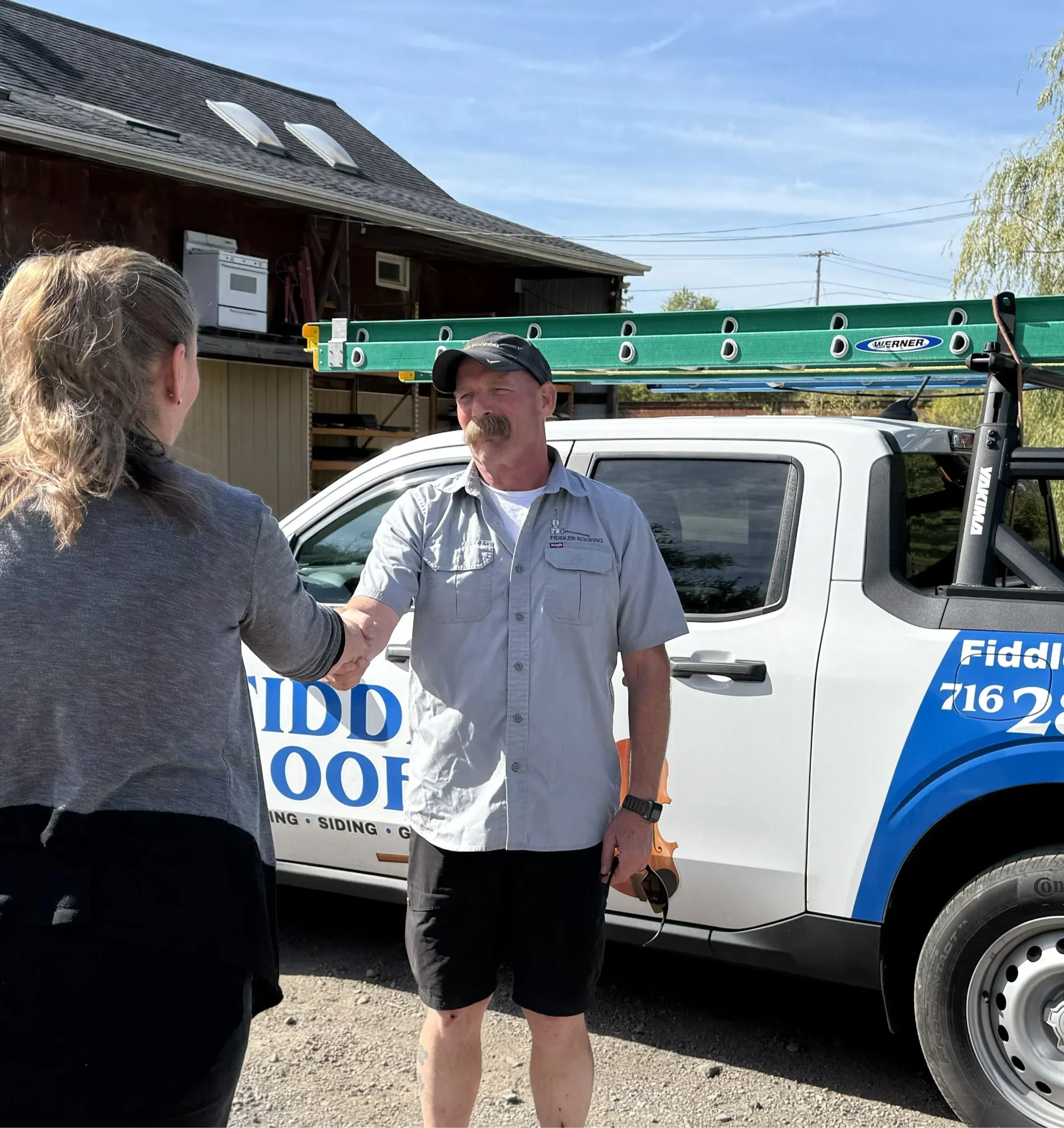 roofing contractor shakes hands with Niagara Falls homeowner during spring roof inspection checklist appointment